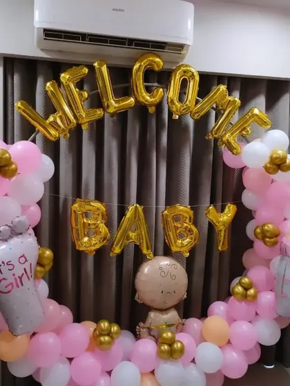 A sweet "Welcome Baby" ring in pink, white, and gold, with "It's a Girl" and baby bottle foil balloons.