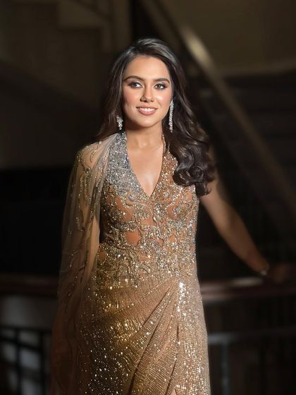 The full-length view of the client in her glamorous gown with old Hollywood waves. The side-part and voluminous curls create a timelessly elegant silhouette.