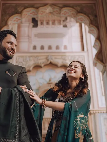 A joyful, candid moment captured in the corridors of a Jaipur palace. The genuine laughter and beautiful architecture come together to create a perfect memory of their pre-wedding journey.