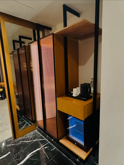 A view of the in-room amenities, including a mini-bar and kettle station. We ensure your guests have everything they need for a convenient and pleasant stay.