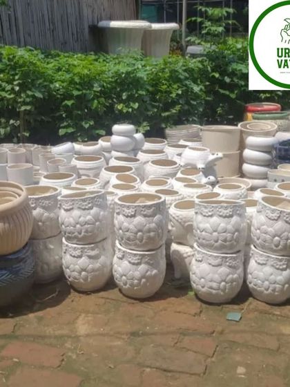 A batch of white ceramic pots with a lace-like texture.