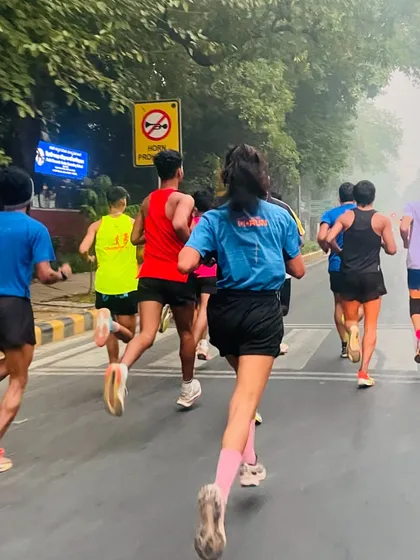 My athletes running on the road during our India Gate run. The mix of male and female runners showcases the inclusive nature of our training group.
