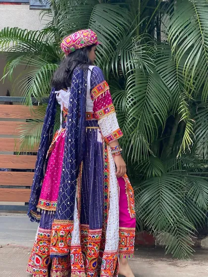 A view from the back, showing the beautiful fall of the fabric and the detailed embroidery on this unique dhoti-style outfit.