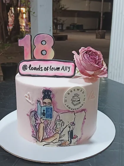 A personalized 18th birthday cake with a hand-painted illustration and a fresh rose.