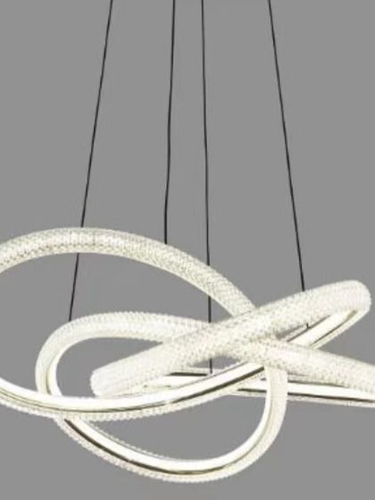 An abstract LED pendant with loops of crystal-studded light. This fixture acts as a hanging sculpture, perfect for making a statement in a modern home.