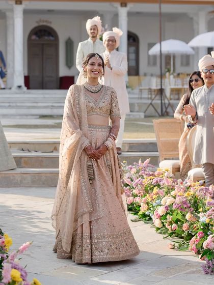 The bride's joyful entrance, walking down an aisle of pastel blooms. Her smile says it all. My goal is to create a setting so beautiful that the moments within it become effortlessly magical.