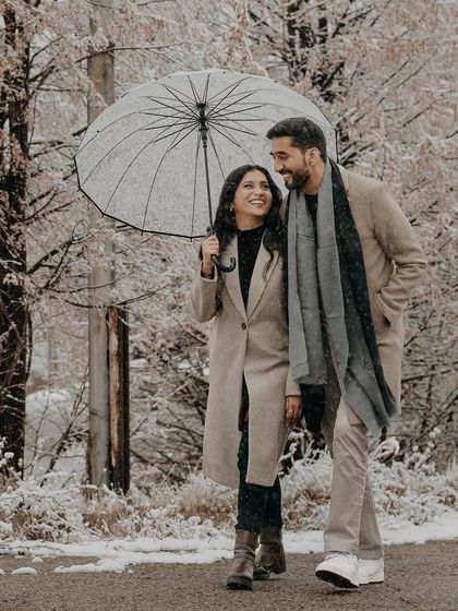 A walk through a winter wonderland in Almaty. This candid couple portrait showcases the cozy romance of a pre-wedding shoot in the snow.