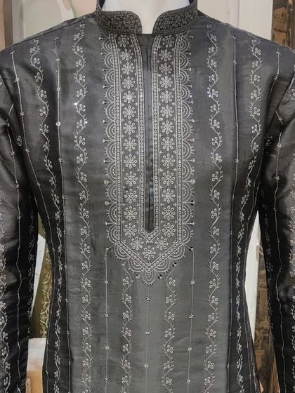 A sophisticated black kurta with intricate silver threadwork. The detailed embroidery on the neckline and down the front makes this a standout piece for an evening event.