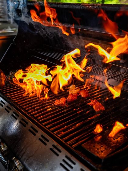 The dramatic flare of open flames on the grill during our Malabar food festival. This technique imparts a unique smoky flavor to the dishes, adding another layer of authenticity to the experience.