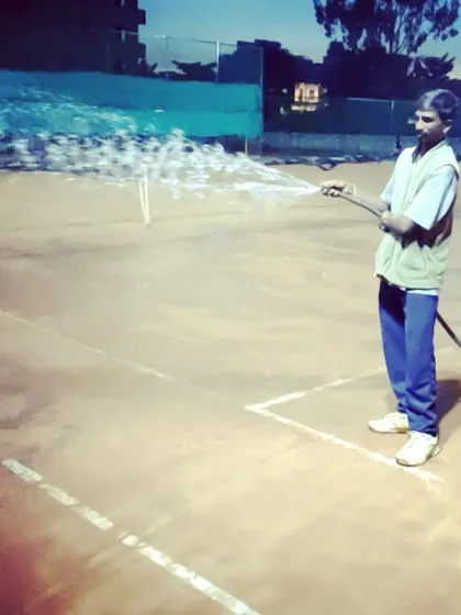 My staff performs daily court maintenance, watering the clay surface to ensure optimal playing conditions for every tournament match.