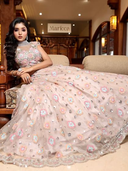 Glam, grace, and elegance. This bride looks like she's stepped out of a magazine, with her stunning pastel lehenga and flawless makeup.