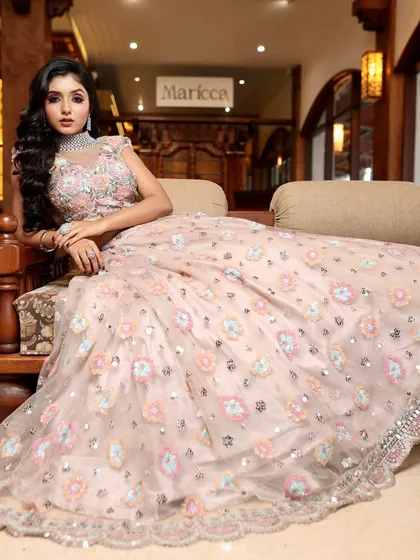 Glam, grace, and elegance. This bride looks like she's stepped out of a magazine, with her stunning pastel lehenga and flawless makeup.