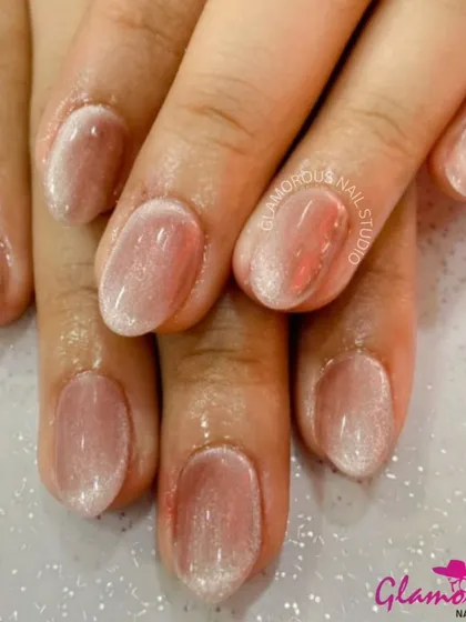 A clean and classic look, these nails feature a sheer, shimmery polish that gives a "your nails but better" effect.