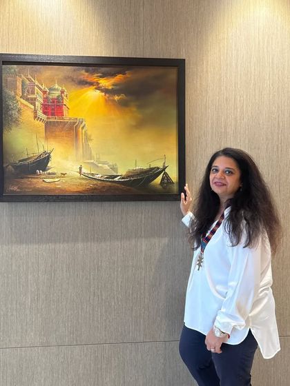 This dramatic landscape painting of Banaras ghats brings so much depth and emotion to the room. The warm, golden light in the artwork is a beautiful contrast to the cool, textured wallpaper.