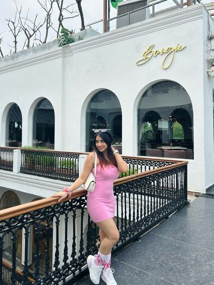 A cute pink dress at Bougie cafe. The white architecture of the cafe provides a beautiful, clean backdrop.