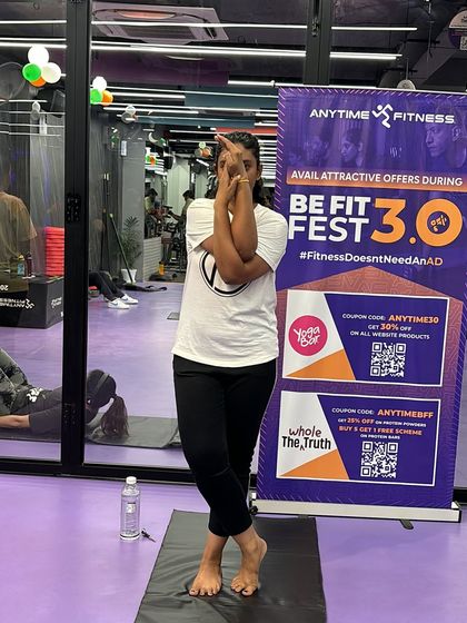 This participant shows her balance and strength during our Be Fit Fest yoga challenge, holding a perfect Eagle Pose.