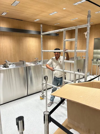 A member of our team working on the scaffolding during the fit-out of the Apple store. The interior features custom stainless steel fixtures and wood paneling, all imported and installed with the pin-point precision required by the client.