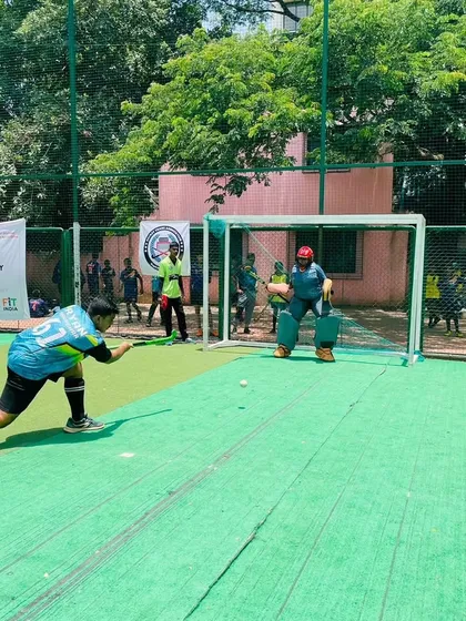 A player practices their drag-flick, aiming for the corner of the goal. This is an advanced skill that we break down and practice extensively.