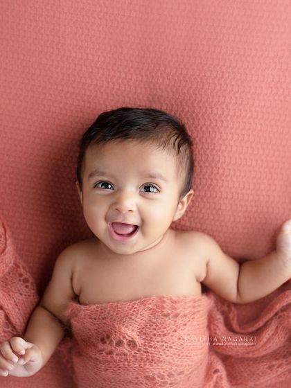 An older newborn, full of smiles and personality. This photo shows that even if you miss the first two weeks, we can still capture beautiful, expressive portraits.
