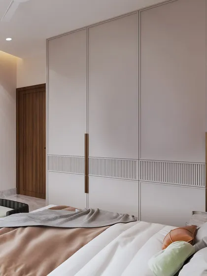 A detail shot of the minimalist wardrobe with its clean lines and integrated handles.