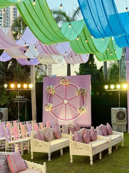The full outdoor setup with the Ferris wheel backdrop, pastel drapes, and elegant seating.