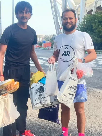 Handing over bags of new shoes and apparel to a promising young runner. This is the most fulfilling part of my work.