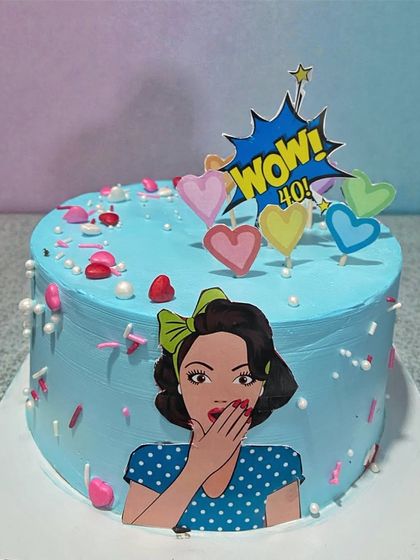 A fun, pop-art themed cake for a fabulous 40th birthday. The bright blue frosting and "WOW! 40!" topper make it a playful and vibrant celebration cake.