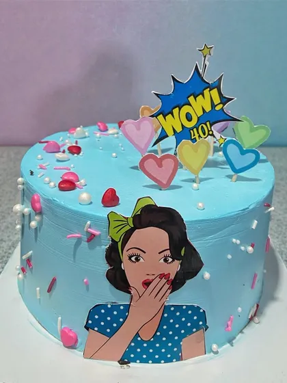 A fun, pop-art themed cake for a fabulous 40th birthday. The bright blue frosting and "WOW! 40!" topper make it a playful and vibrant celebration cake.