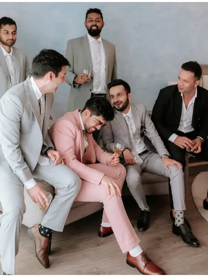 The groom sharing a laugh with his best men. The camaraderie and fun of the groom's squad is an essential part of the celebration.