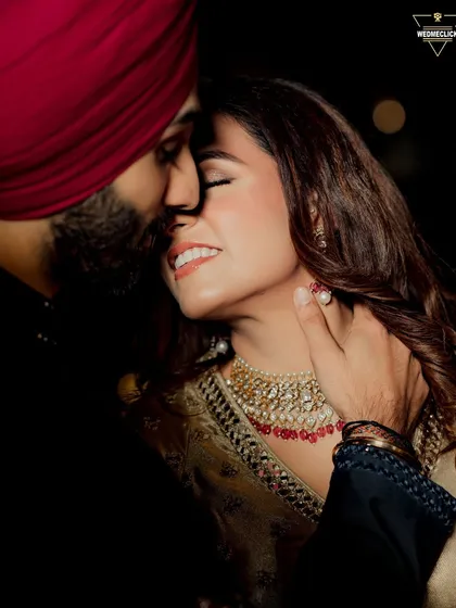 An intimate close-up of the couple, their faces close together, capturing a moment of pure connection and love.