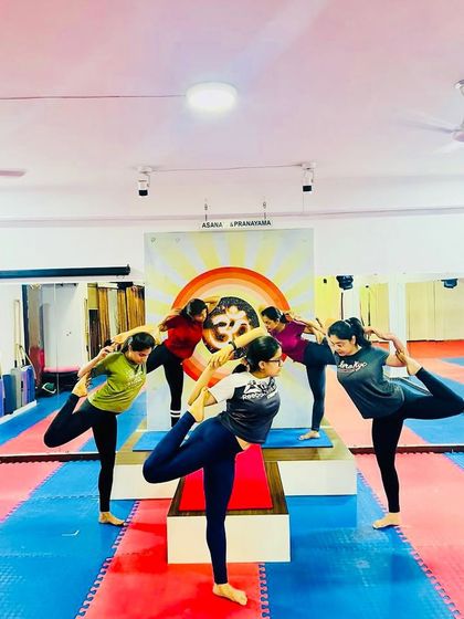 Students practice Natarajasana (Lord of the Dance Pose) together, a standing pose that cultivates balance, focus, and grace.