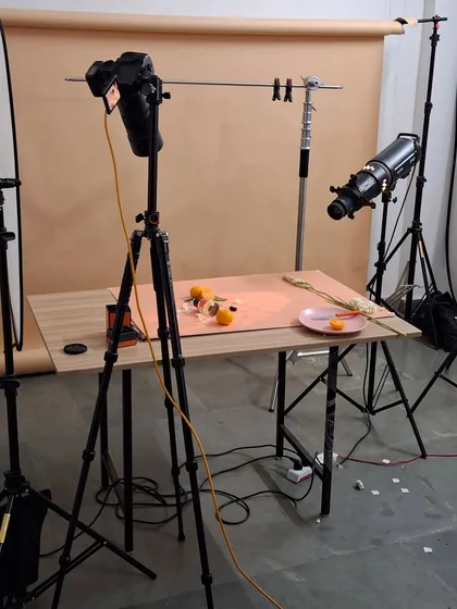 The full setup for a fresh and citrusy fragrance shoot. You can see our overhead camera rig, lighting equipment, and the arrangement of props on the table.