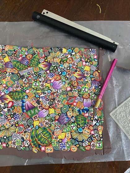 My work table during the clay-making process. You can see the slab of patterned clay, my tools, and a texture sheet I use for the back of the dishes.