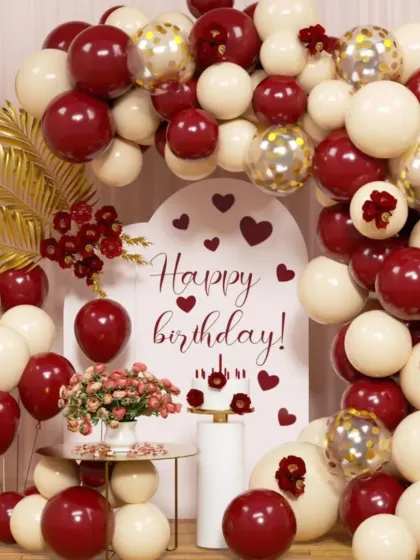 A romantic birthday setup with a heart-filled backdrop. The rich burgundy and cream balloons create a warm and loving atmosphere, perfect for celebrating someone special.
