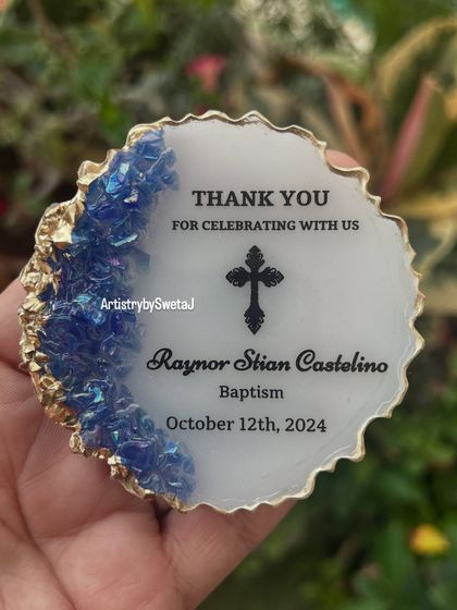 A close-up of the baptism magnet, showcasing the iridescent blue crystals and crisp, clear text.