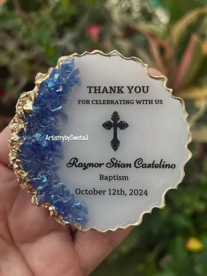 A close-up of the baptism magnet, showcasing the iridescent blue crystals and crisp, clear text.