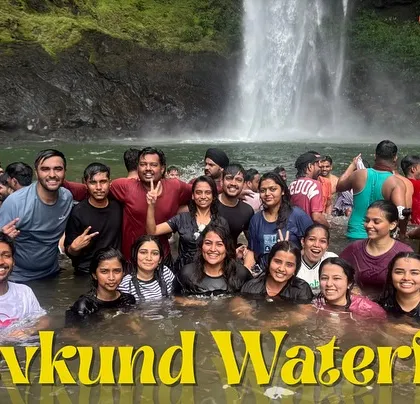 A group photo of our trekkers enjoying the plunge pool at Devkund Waterfall in Maharashtra.