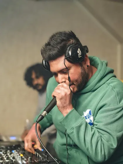 On the mic again, hyping up a back-to-back set. The energy is doubled.