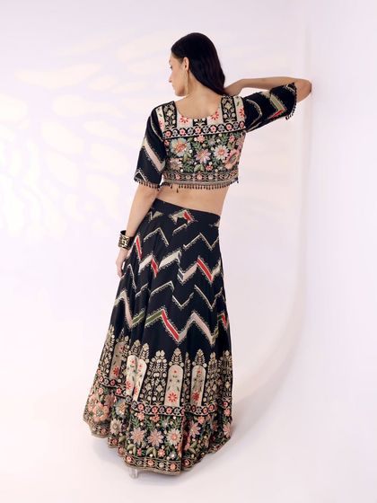 The back of this blouse is a work of art, with floral embroidery extending across the shoulders and a modern square neckline.