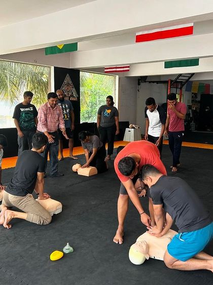 A wide shot of our members practicing CPR on dummies during the first aid workshop.