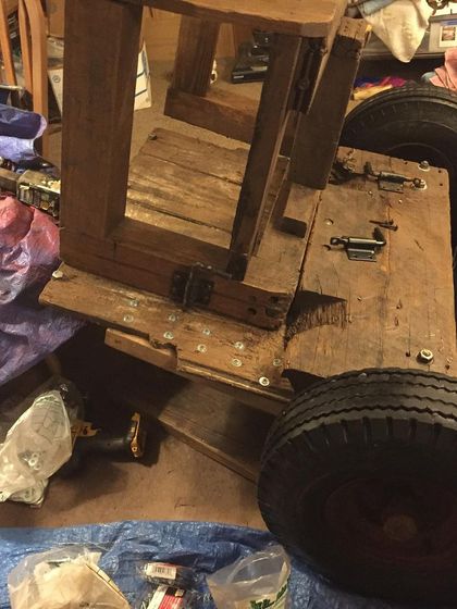 The barrel cart repair project, taking up space in our home. We do what we have to do to keep the operation running, even if it means a messy living room.