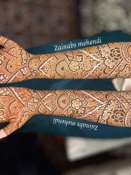 A beautiful example of full coverage bridal henna. The design flows seamlessly from the fingertips to the elbows, creating a breathtaking effect.