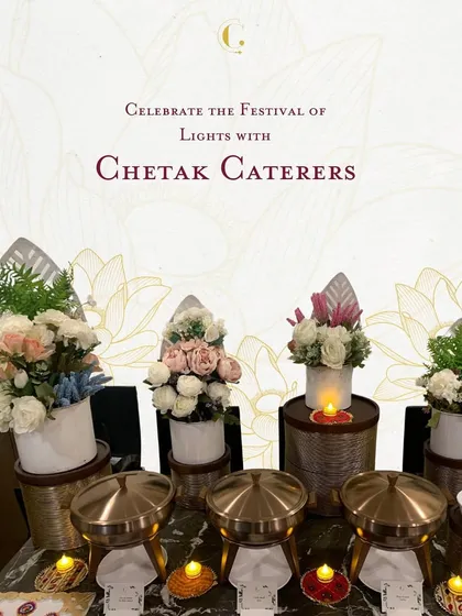 A festive buffet setup for Diwali, adorned with candles and traditional brass serving dishes. The decor is designed to reflect the warmth and light of the festival.