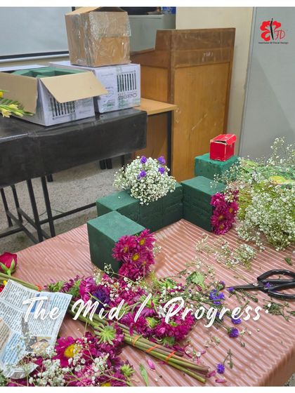 A mid-progress shot of the Ganpati floral challenge. You can see the floral foam structure and the initial layers of flowers, giving a behind-the-scenes look at how these creations come together.