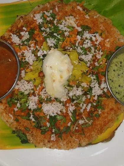A feast for the eyes and the palate. This is our special open-faced masala dosa, generously topped with grated carrots, fresh coconut, and coriander, finished with a scoop of white butter. It’s a vibrant and flavourful dish that we love serving at breakfast counters for weddings and events.