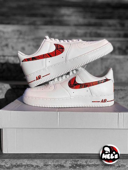 A classic product shot of the MotoGP custom Nikes stacked on their box.