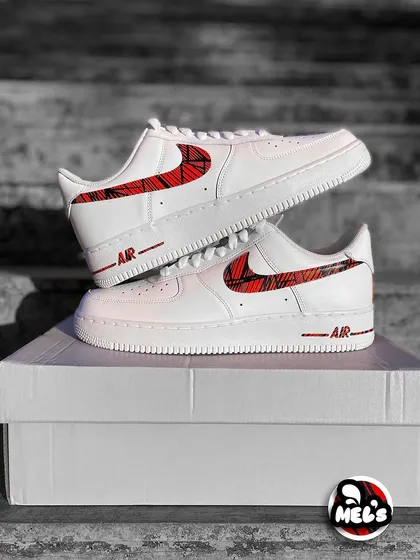 A classic product shot of the MotoGP custom Nikes stacked on their box.
