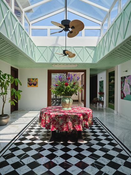 Another view of the atrium, looking up at the skylight and custom fans. The space is designed as an internal courtyard, a place for the family to gather, surrounded by art and seasonal floral displays.