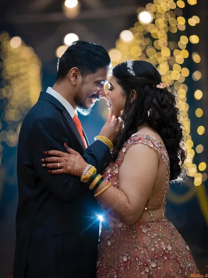 A magical engagement portrait of Anuja and Vikram, surrounded by the warm glow of bokeh lights. This creates a dreamy and celebratory atmosphere.