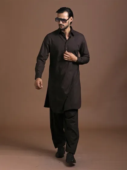 A classic Pathani suit in a rich, dark brown. The clean lines and relaxed fit offer a look of timeless charm and masculine grace. It’s a versatile ensemble that is both comfortable and effortlessly stylish.